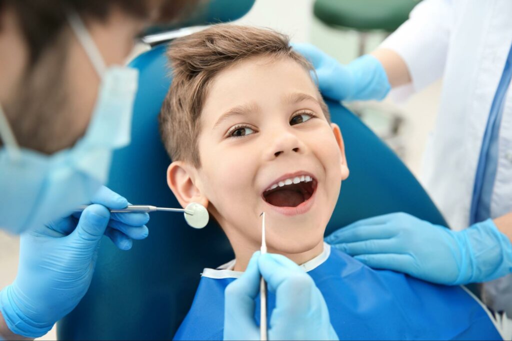 Dentiste vérifiant les dents de l'enfant